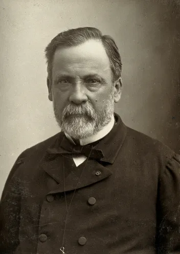 Studio portrait of Louis Pasteur, a bearded man in a dark coat and bow tie.